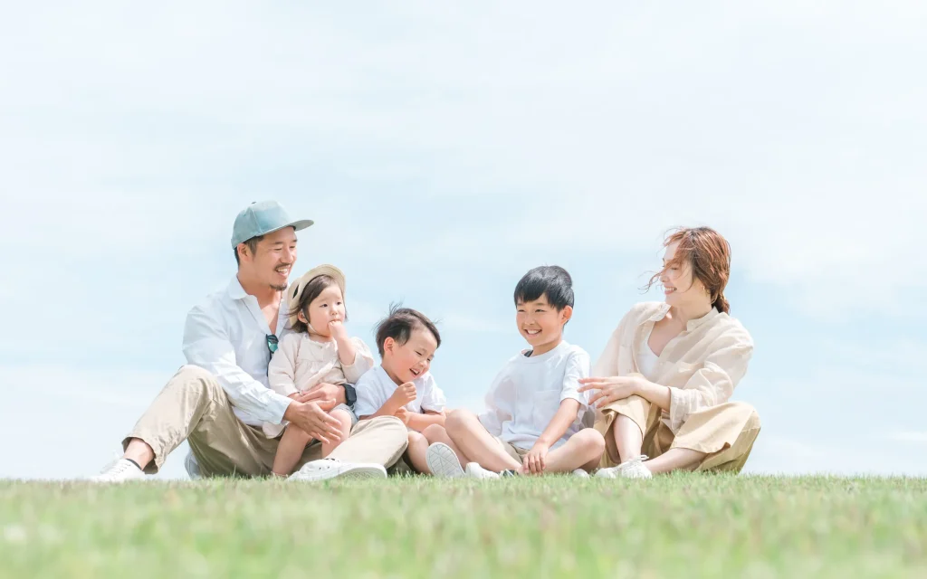 木陰の丘でくつろぐ家族